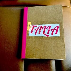 I am selling a pink notebook that says Talia. I can put any name you want on it!